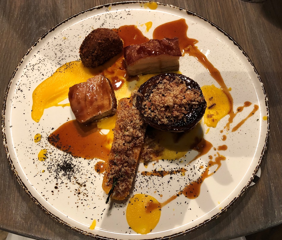 pressed pork belly with pork loin and croquette, braised carrot, onion, black garlic and jus