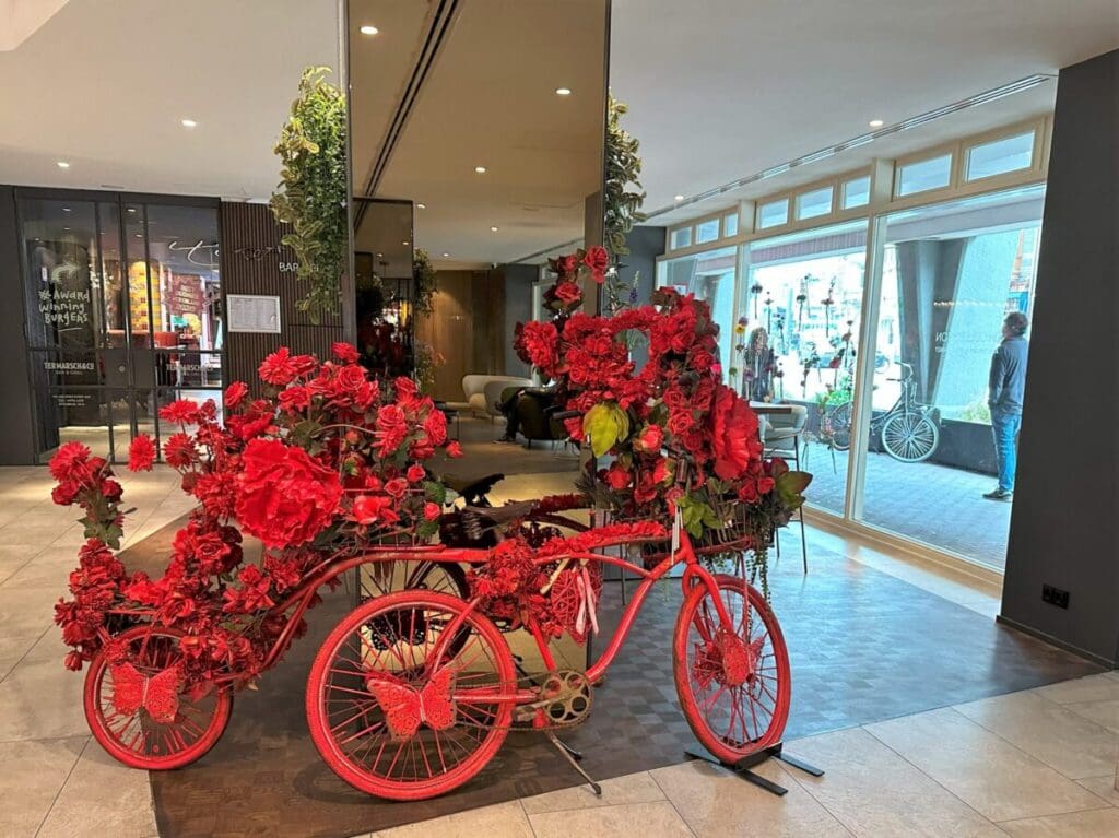 Red bicycle in lobby of NH Collection Amsterdam Flower Market