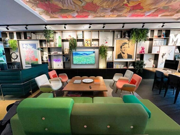 The living room area at citizenM Amstel Amsterdam hotel has a bespoke painting on the ceiling