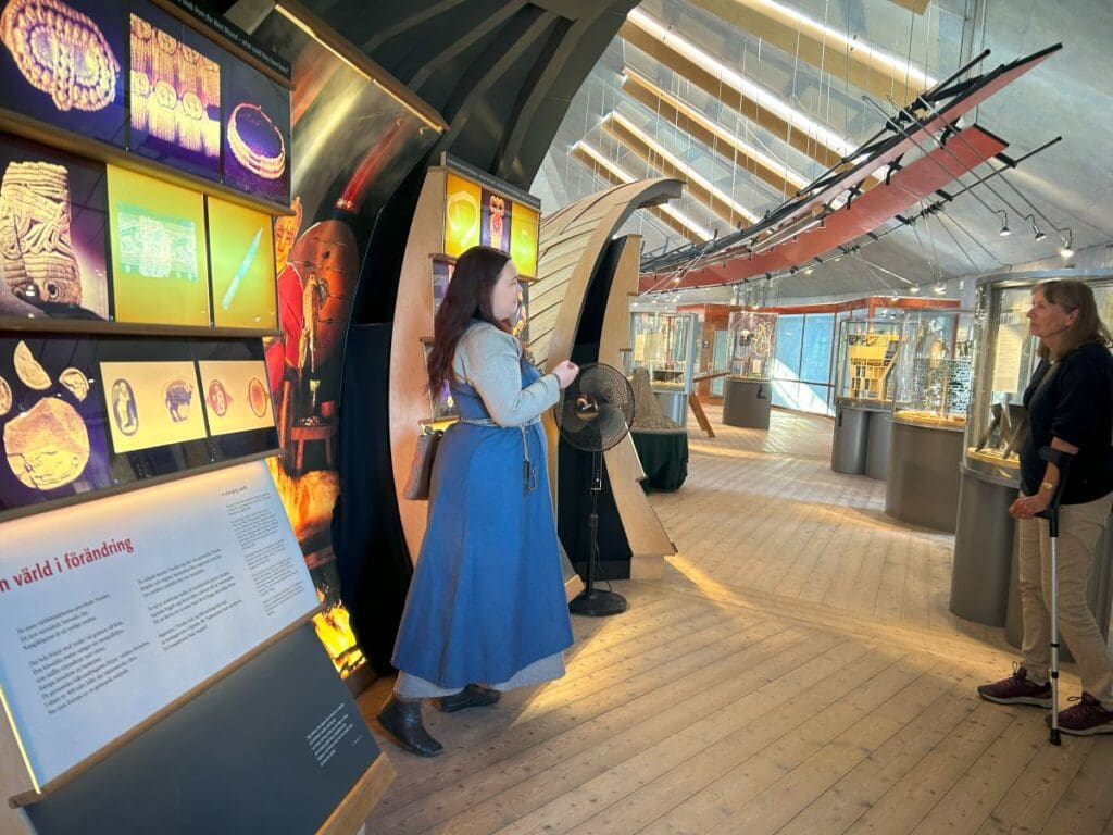 Guides explains a display to visitors at Gamla Uppsala Museum, Sweden