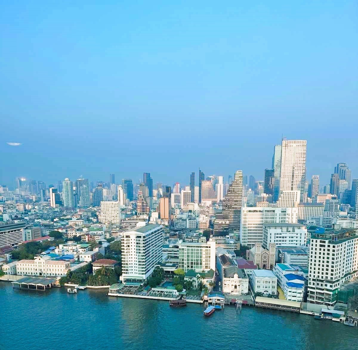 The Peninsula Bankgok towers over the Chao Phraya River with views across the city