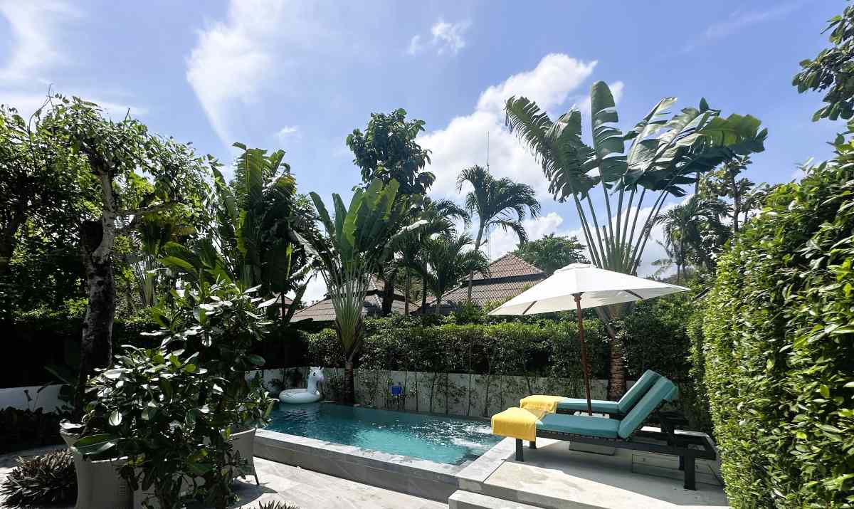NH Collection Samui Peace Resort one bedroom pool villa has a large pool terrace with loungers and an outdoor eating area