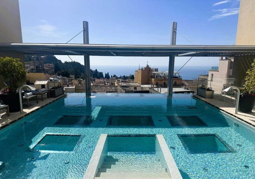 NH Collection Taormina pool deck overlooking the town