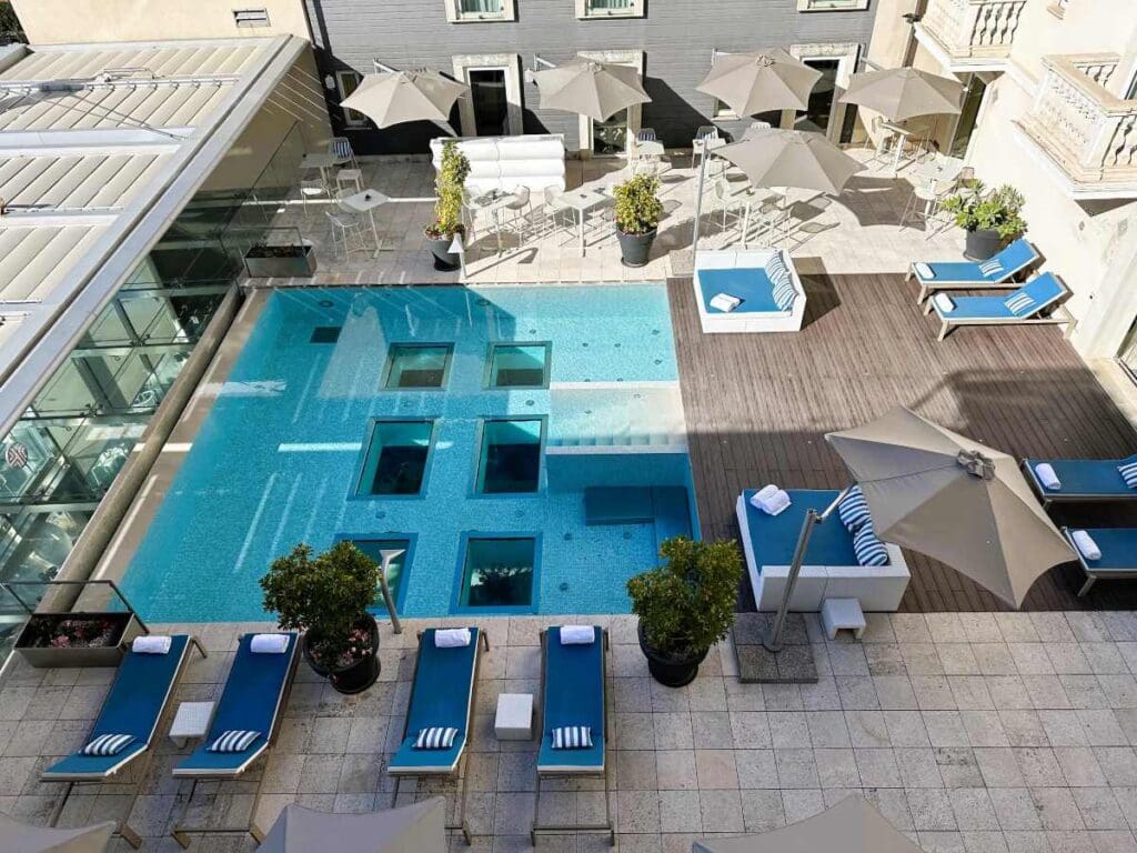 NH Collection Taormina has a large swimming pool on a deck in the central courtyard