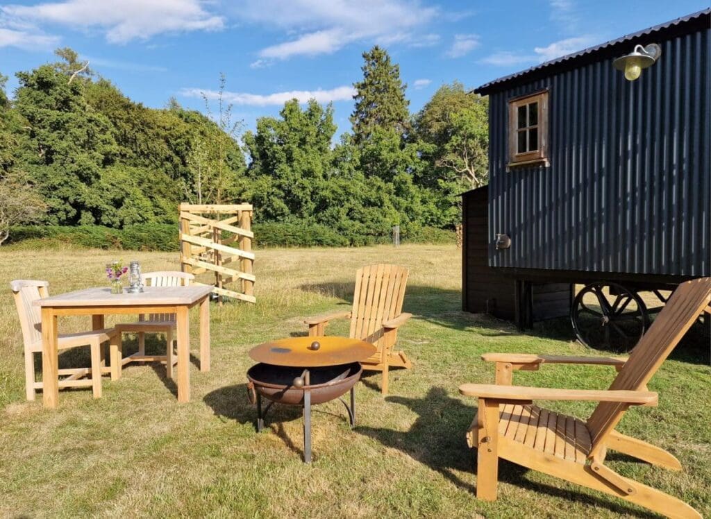 The fire pit and outside dining at the Shepherd's Hut Stonor Park