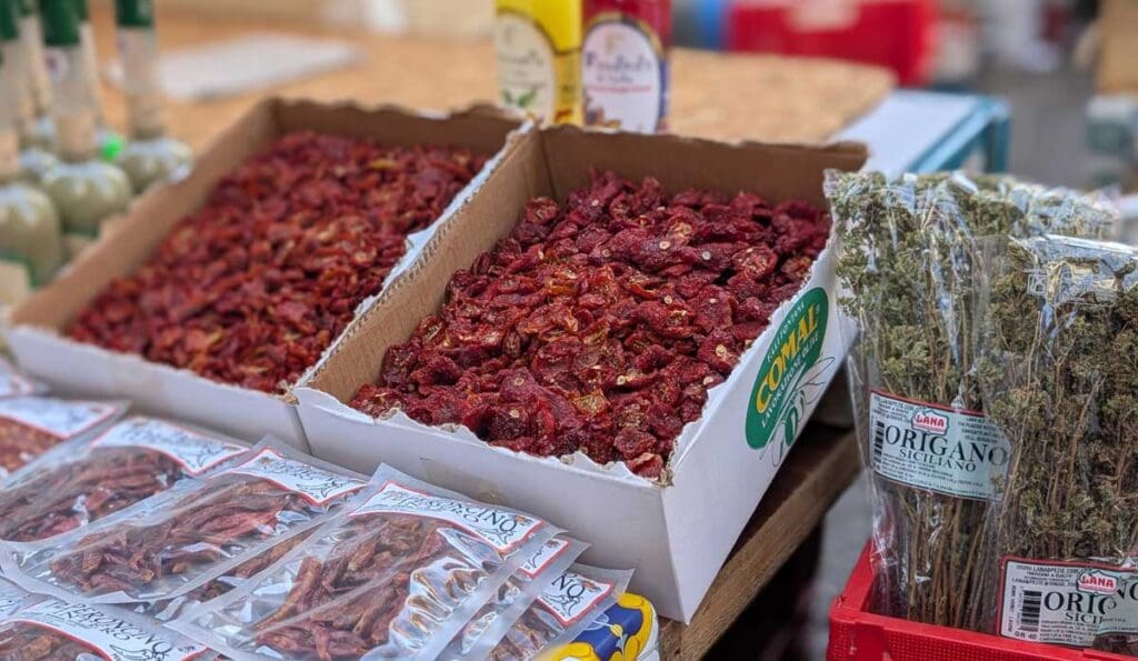 Dried tomatoes, oregano and peppers at the street market