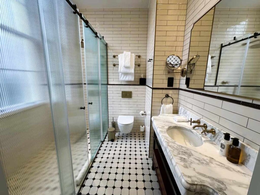 Luxurious bathroom with his and hers showers in the Philosopher's Quarters at Bertrand's Townhouse